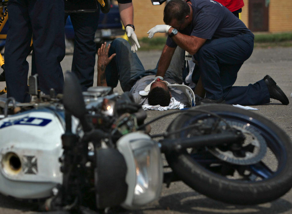 Award of Excellence, Photographer of the Year - Ken Love / Akron Beacon JournalAkron firefighters attend to a victim who lost control of his motorcycle and was injured.  