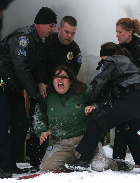 Award of Excellence, Photographer of the Year - Ken Love / Akron Beacon JournalAkron police restrain Daisy Shoff from entering her home to save her pets as firefighters battle an early morning blaze in Akron, Ohio. After numerous attempts to revive her animals, firefighters were able to save one dog but several others and the family's pet bird perished in the fire.