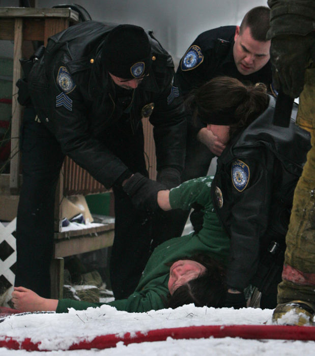 Award of Excellence, Photographer of the Year - Ken Love / Akron Beacon JournalDaisy Shoff is overcome with emotion as Akron Police prevent her from entering her home to save her pets as firefighters battle an early morning blaze. After numerous attempts to revive her animals, firefighters were able to save one dog but several others and the family's pet bird perished in the fire.