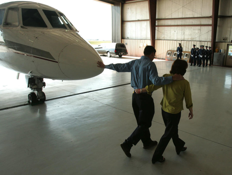 Award of Excellence, Photographer of the Year - Ken Love / Akron Beacon JournalLes Kuglics, arm in arm with his wife, Donna, reaches out to touch the nose of the plane that holds the body of their son, Matthew. Staff Sgt. Matthew J. Kuglics, returning home on a private charter, was killed after an explosive device struck his vehicle while on his second tour of duty in Iraq. 