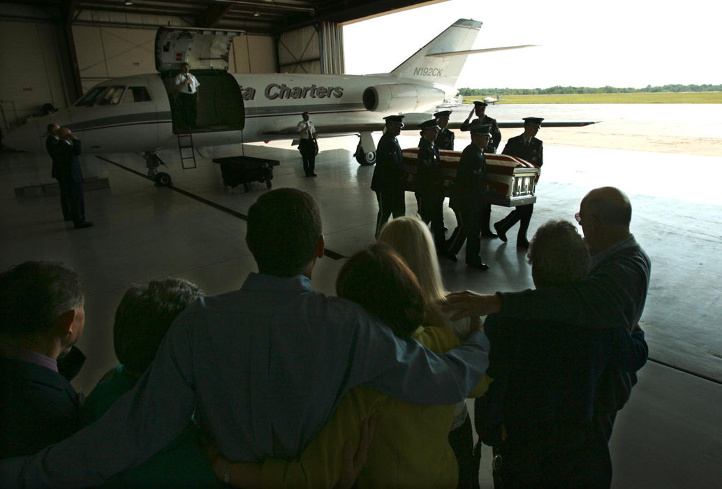 Award of Excellence, Photographer of the Year - Ken Love / Akron Beacon JournalGrieving family members embrace as the flag-draped casket of Air Force Staff Sgt. Matthew J. Kuglics is carried from the plane by honor guard members of the Wright Patterson Air Force Base. 