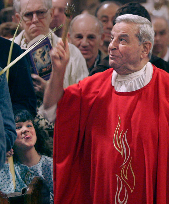 Award of Excellence, Photographer of the Year - Phil Masturzo / Akron Beacon JournalElizabeth Hall, 5, sticks her tongue out at the Rev. James Ragnoni after the priest gave her a playful nudge with his elbow in the back of her head as he walked along the aisle blessing palms with holy water at a Palm Sunday service. 