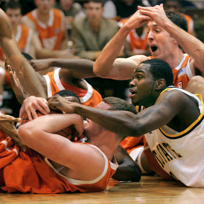 Award of Excellence, Photographer of the Year - Phil Masturzo / Akron Beacon JournalBowling Green's Erik Marschall is swarmed in a loose ball pile-up during the first half action at Kent State University's MAC Center on Saturday January 20, 2007 in Kent, Ohio. BG's Dusan Radivojevic is behind calling time out.  