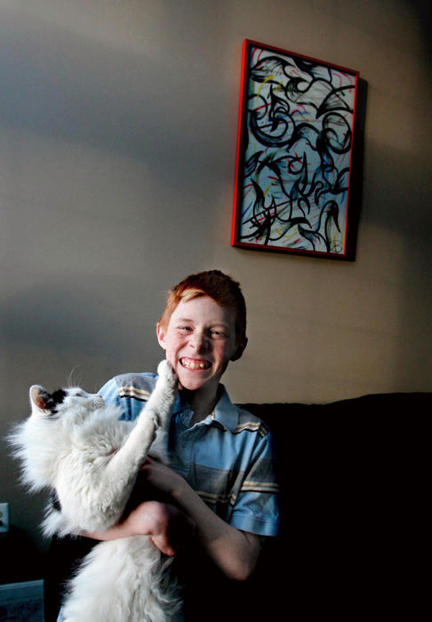 Award of Excellence, Photographer of the Year - Phil Masturzo / Akron Beacon JournalAlec Pinter,11, diagnosed with autism,  poses for a portrait with  his cat, Billy, at their Cuyahoga Falls home. 
