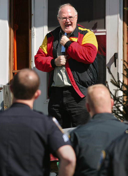 Award of Excellence, Photographer of the Year - Phil Masturzo / Akron Beacon JournalAkron police officers talk to Alexander Campbell, 55, as he holds a knife to his throat at his home on Idaho Avenue during an hour-long standoff. Before police arrived Campbell had that same knife pressed to the throat of his estranged wife, Candy Campbell.The standoff ended when Campbell was tasered and placed in custody. 