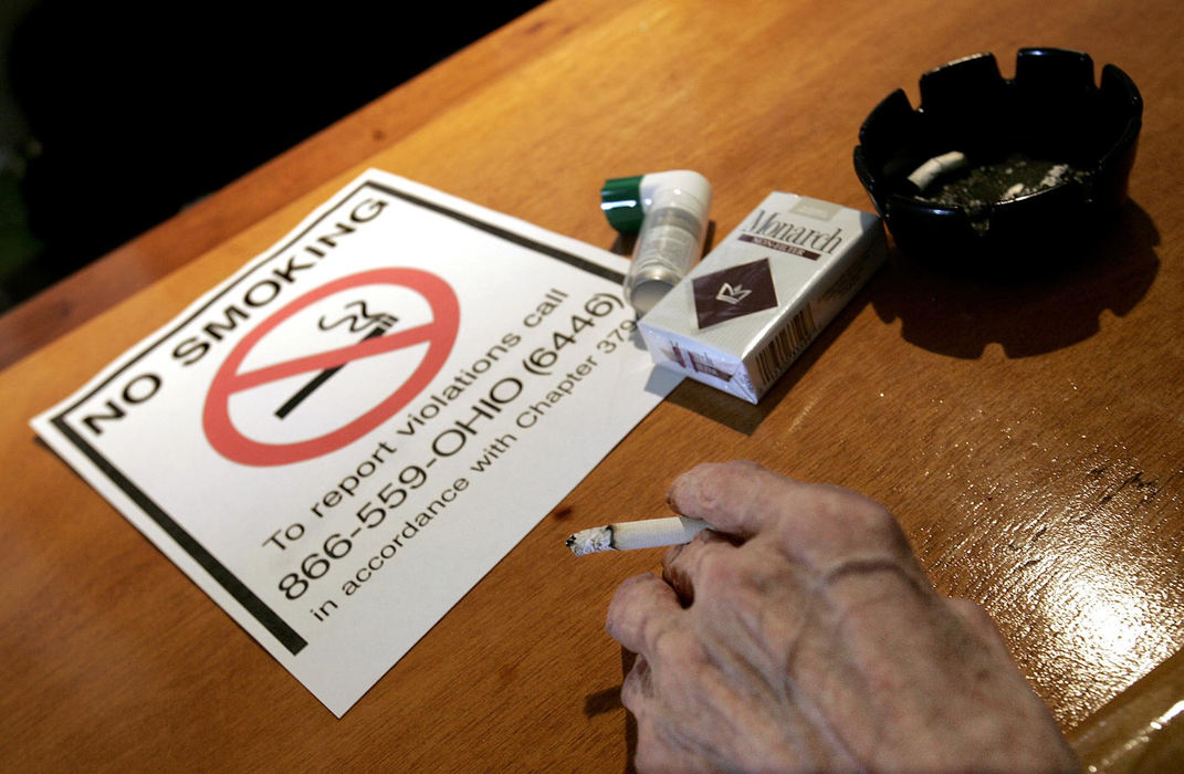 First Place, Photographer of the Year - Chris Russell / The Columbus DispatchWorld War II veteran Charles Armentrout enjoys a last smoke at his local VFW before they post the sign to ban smoking there.  Ohio courts ruled that even private businesses and clubs had to abide by the statewide smoking ban.