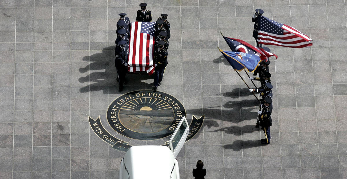 First Place, Photographer of the Year - Chris Russell / The Columbus DispatchA flag draped casket bearing Rep. Paul Gillmor is taken from the Ohio Statehouse after a memorial service and a public viewing in the rotunda.  The Republican Congressman died after an accidental fall down stairs in his Washington town house.  