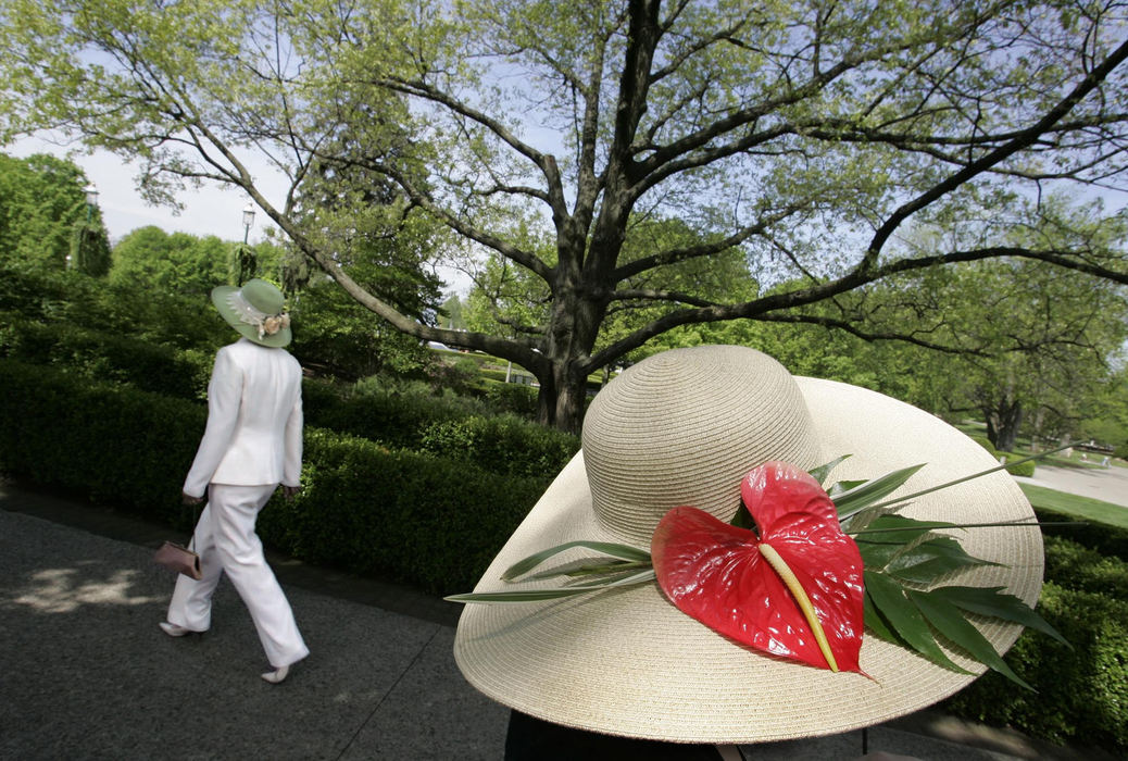 First Place, Photographer of the Year - Chris Russell / The Columbus DispatchSporting an oversized wide brimmed hat Christy Cox greets arrivals to the Annual Hat Day event at the Franklin Park Conservatory that raises funds for the facility. 