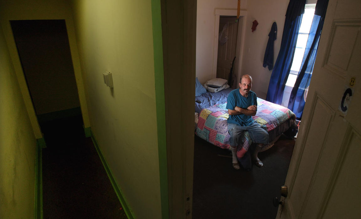 First Place, Photographer of the Year - Chris Russell / The Columbus DispatchLabeled a sexual predator, Albert Walters lives in this small room in a boarding house in a poor section of Newark, OH that he shares with other sexual offenders.  A growing number of communities are restricting where these offenders can live after they leave prison .