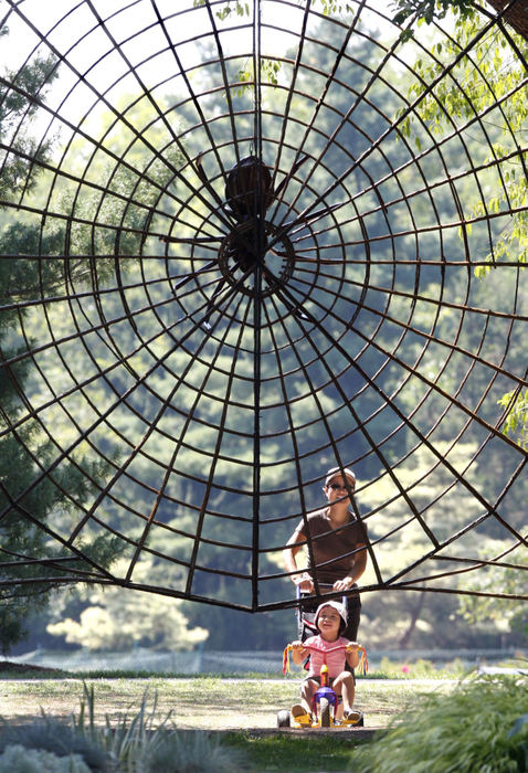 First Place, Photographer of the Year - Chris Russell / The Columbus DispatchAlthough their path was blocked,  there was no sign of arachnophobia from three year old Simone Gorman as her mother, Pauline Wong wheeled her up to this oversized spiderweb at Inniswood Metro Gardens in Westerville.  The Westerville residents were discovering the David Rogers Big Bugs exhibit that was on display. 