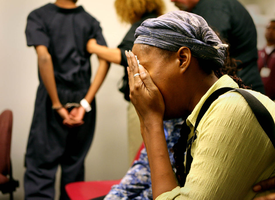 Second Place, Photographer of the Year - Lisa DeJong / The Plain DealerDamika McIntyre, mother of Davonta McIntyre, 14, in handcuffs on left, cries as he is lead out of his hearing at Cuyahoga County Juvenile Court. McIntyre is one of the four teenagers riding in a stolen car that killed a Brecksville grandmother in Cleveland's theater district. Virginia DiGiorgio, 57, was struck while crossing Prospect Avenue with her husband to see a performance of "The Lion King." She died at MetroHealth Medical Center shortly after being hit.