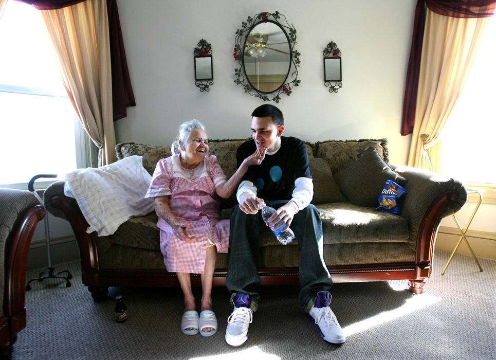 Second Place, Photographer of the Year - Lisa DeJong / The Plain DealerLaureana Colon, 93, touches the face of her grandson Ramon Diaz, 18, while he sits with her during his daily visit after school at her home in Ohio City. Ramon, a senior at St. Ignatius High School, who grew up poor but loved, will be the first one in his large family to attend college. " If I didn't have my family, I wouldn't even be in school right now," Diaz who has a full-ride scholarship to Columbia in New York City said. "I was given the opportunity to go for it and I will. Until I'm in my grave, I'm not going to quit."