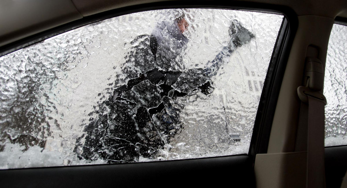 First Place, Photographer of the Year - Chris Russell / The Columbus DispatchSue Grogan left work early only to find her car encased in ice.  Heavy snow was the problem for her driving into work, getting the ice off was the problem after freezing rains hit.  