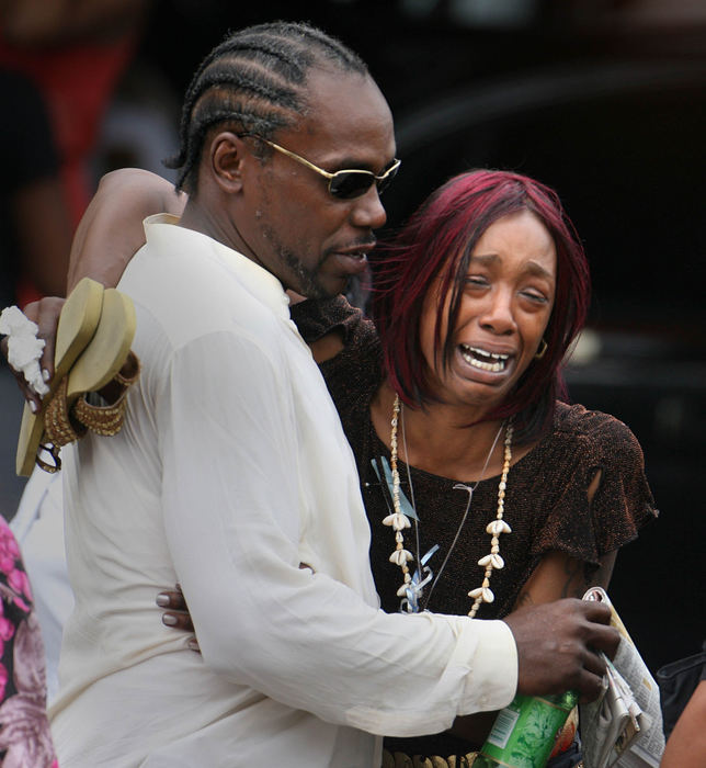 Second Place, Photographer of the Year - Lisa DeJong / The Plain DealerTracy Griffin (right) is helped by a friend as she cries while walking out of the funeral service for her niece Asteve' Thomas. Thomas was the youngest of 13 children. 