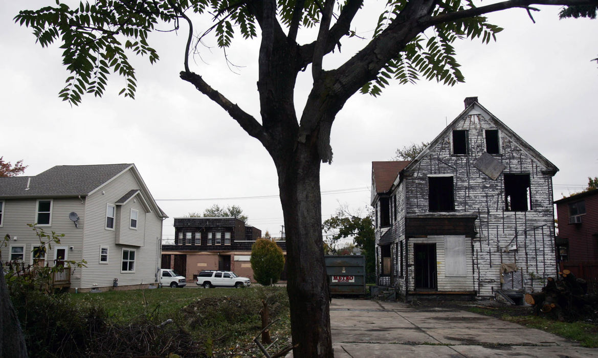 Third Place, Photographer of the Year - Gus Chan / The Plain DealerA Slavic Village home that has all its siding stripped next to a nicer home in the community.