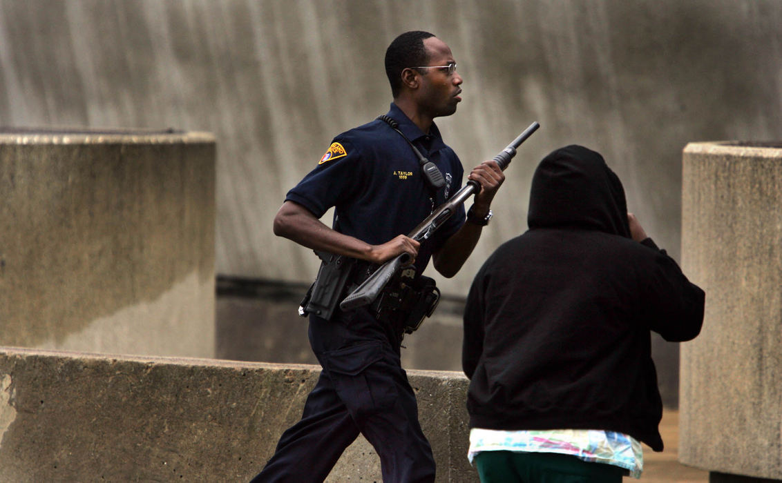 Third Place, Photographer of the Year - Gus Chan / The Plain DealerA Cleveland police officer runs into Success Tech School after a student opened fire shooting a teacher and students before turning the gun on himself.