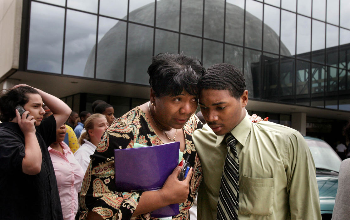 Third Place, Photographer of the Year - Gus Chan / The Plain DealerStudents and faculty huddle outside of Success Tech School after a student opened fire shooting a teacher and students before turning the gun on himself.