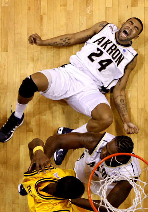 Award of Excellence, Sports Feature - Lonnie Timmons III / The Plain DealerUniversity of Akron's Romeo Travis falls hard after taking a shot during the second half of their game against Kent State University at Rhodes Arena in Akron.