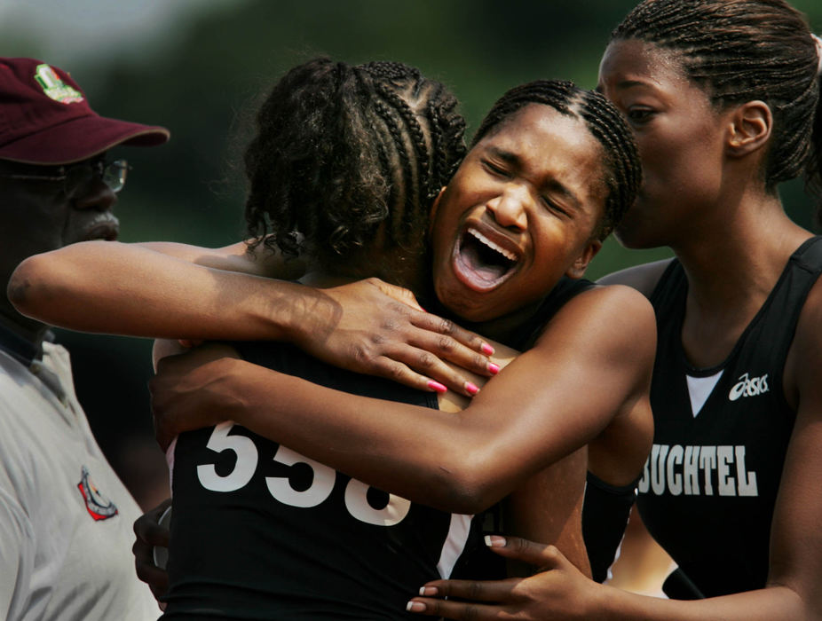 Second Place, Sports Feature - Gus Chan / The Plain DealerAkron Buchtel's Tiffany Tucker (center) hugs teammate Kachay Hullum (left) after winning the Division II 4X400 meter relay.  Teammate Chelsea James is also in on the celebration. Buchtel won the girls Division II team title. 