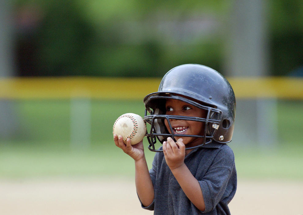 Award of Excellence, Sports Feature - Kyle Robertson / The Columbus DispatchTrulanie Hardgrow shows off a rag-ball to his father after hitting the ball off the tee and chasing it down during his first ever practice. Trulanie was already lectured by his father not to chasing down his ball after hitting the ball off the tee. Turlanie proceeded to chase down his ball again and then turned to his father and said, "Dad I got it!" 