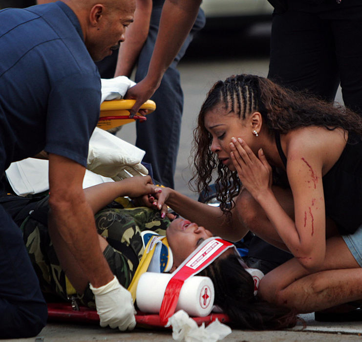 Second Place, Spot News over 100,000 - Lew Stamp / Akron Beacon JournalOne victim consoles a, more seriously injured, friend at a traffic crash at Voris and Broadway with six victims,July 4, 2007 in Akron.