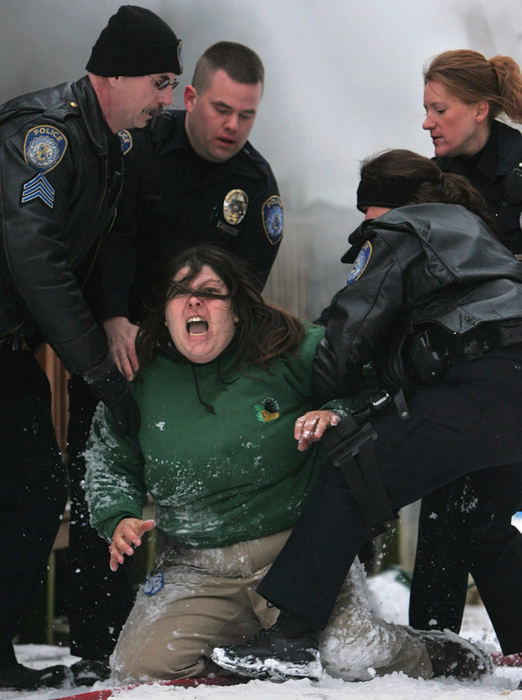 Award of Excellence, Spot News over 100,000 - Ken Love / Akron Beacon JournalAkron police restrain Daisy Shoff from entering her home to save her pets as firefighters battle an early morning blaze. After numerous attempts to revive her animals, firefighters were able to save one dog but several others and the family's pet bird perished in the fire.