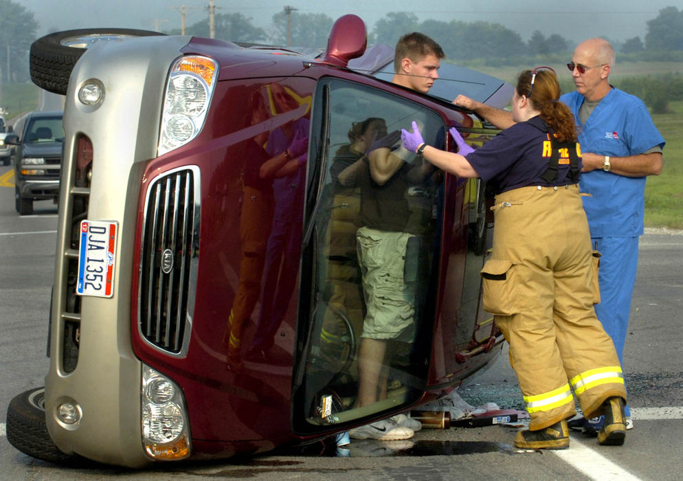 Second Place, Spot News under 100,000 - Marshall Gorby / Springfield News-SunWhile standing inside the van he was driving, John Schultz, 18, of New Carlisle talks with Bethel Township Fire Department medic, Jennica Stout and bystander Larry Tate, after he was involved in a two vehicle accident at the intersection of West National and Medway-Carlisle roads.