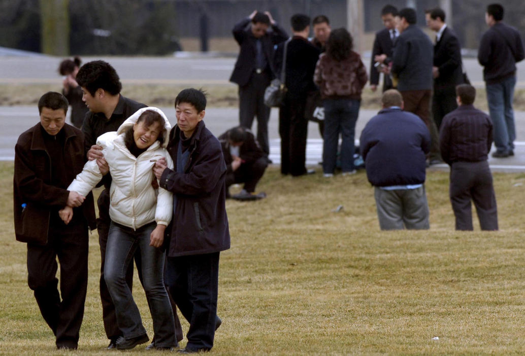 Award of Excellence, Spot News under 100,000 - Marshall Gorby / Springfield News-SunGrief overcomes some of the family members of the three Chinese students from Urbana University as they view the intersection of Urbana Road and Moorefield Road where their loved ones were killed in a traffic accident last week. 