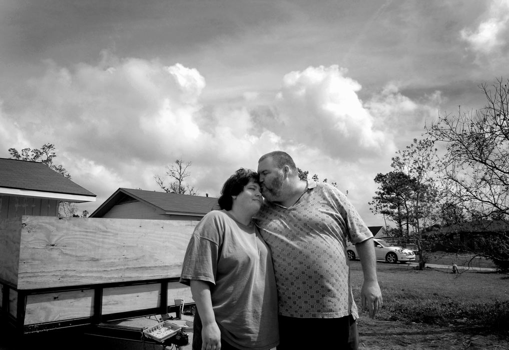 First Place, Student Photographer of the Year - David Foster / Kent State UniversityJim Jackson of Gulf Port, Miss. gives his girlfriend Chris a kiss after a long day of helping Kent State volunteers rebuild their home. Since Katrina hit they have lived in a FEMA trailer and with the help of the volunteer groups they are getting closer to finishing their home.
