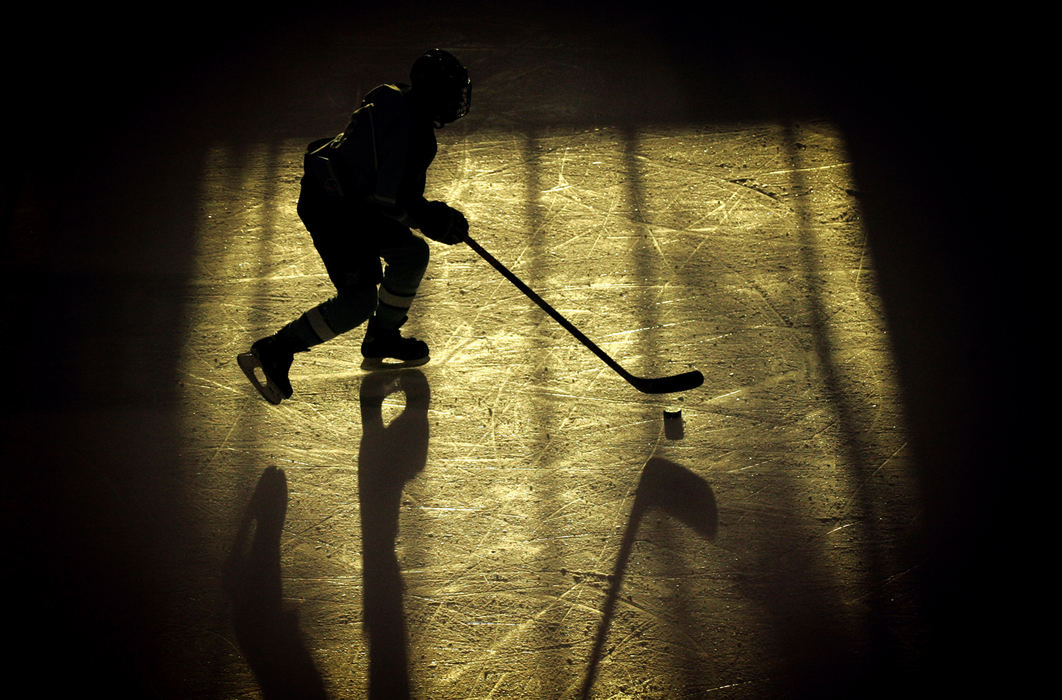 First Place, Student Photographer of the Year - David Foster / Kent State UniversityA junior league hockey player skates across the ice with the puck at the Dispatch Ice Haus in Columbus.