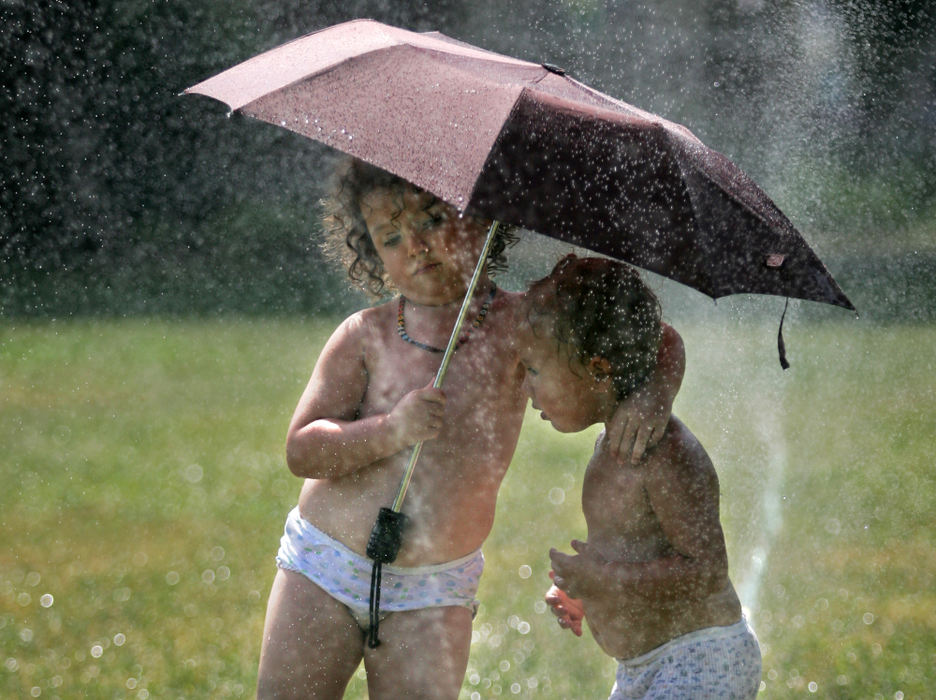 First Place, Student Photographer of the Year - David Foster / Kent State UniversityRuby Richardson, 4, puts her arm around her brother Scout, 2, as they play in the sprinklers at Comfest in Goodale Park in Columbus, September 22, 2007. 