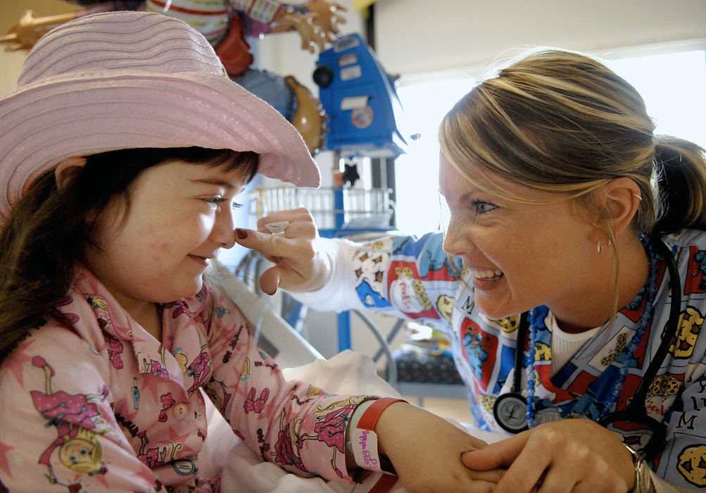 First Place, Student Photographer of the Year - David Foster / Kent State UniversityNurse Tiffany Bryant gives Shyann Butcher, 5, a poke on the nose that magically honks when she pushes. Bryant along with other members of Children's Hospital were taught tricks by a local magician to entertain and help children relax.  