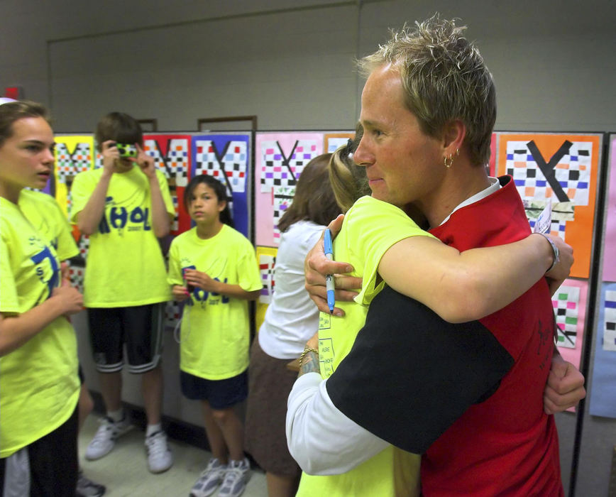 First Place, Sports Picture Story - Andy Morrison / The BladeTodd Crandall gets a hug after speaking to eighth grade students at St. Rose Elementary School in Perrysburg, during Teens High On Life Week.
