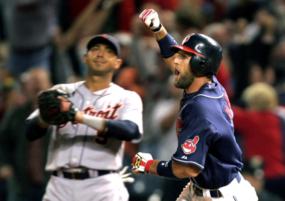 Second Place, Sports Picture Story - Chuck Crow / The Plain DealerCleveland Indians Casey Blake pumped his fist rounding first base after hitting a walk-off homer against the Detroit Tigers in the 11th inning to beat the Tigers 6-5 at Jacobs Field. Behind Blake is a bummed Detroit Tigers first baseman Carlos Guillen. The victory gave the Indians a commanding lead over the Tigers in The Central Division race that Detroit never overcame. Regular season game of the year for the Indians.