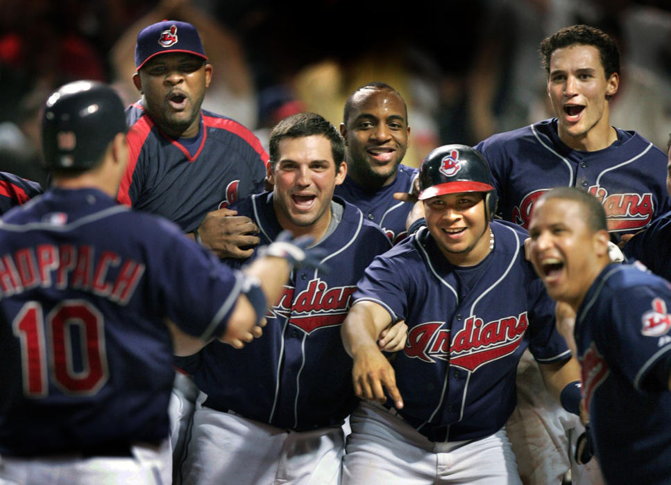 Second Place, Sports Picture Story - Chuck Crow / The Plain DealerA welcoming committee waits for Cleveland Indians' Kelly Shoppach at home plate after Shoppach hit a walk-off three-run homer to beat the Oakland Athletics 8-5 in a baseball game in Cleveland. Indians Jhonny Perolta is pointing to home plate, reminding that the play does not count until Shoppach touches home plate.