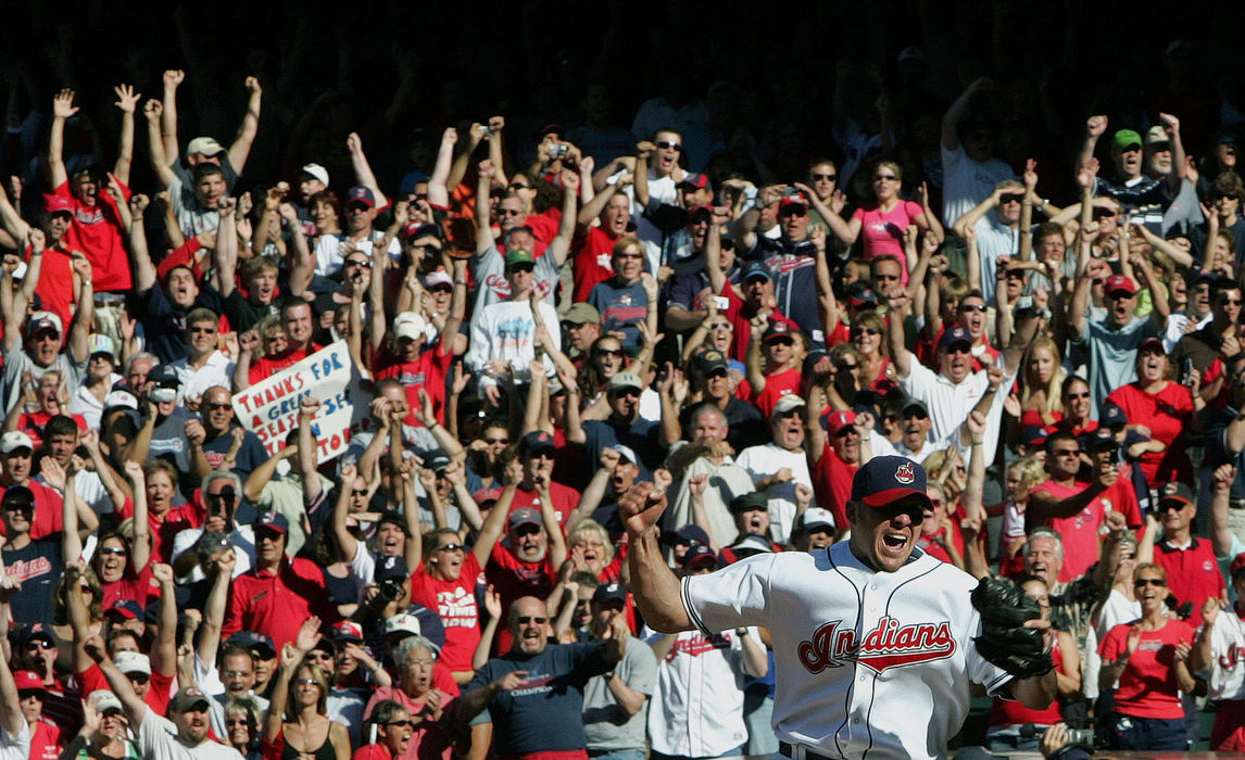 Second Place, Sports Picture Story - Chuck Crow / The Plain DealerWith the sold out Jacobs Field fans going wild behind him, Indians relief pitcher Rafael Betancourt celebrates after striking out the last Oakland A's batter as the Indians win to clinch their first AL Central Division title and playoff appearance since 2001.