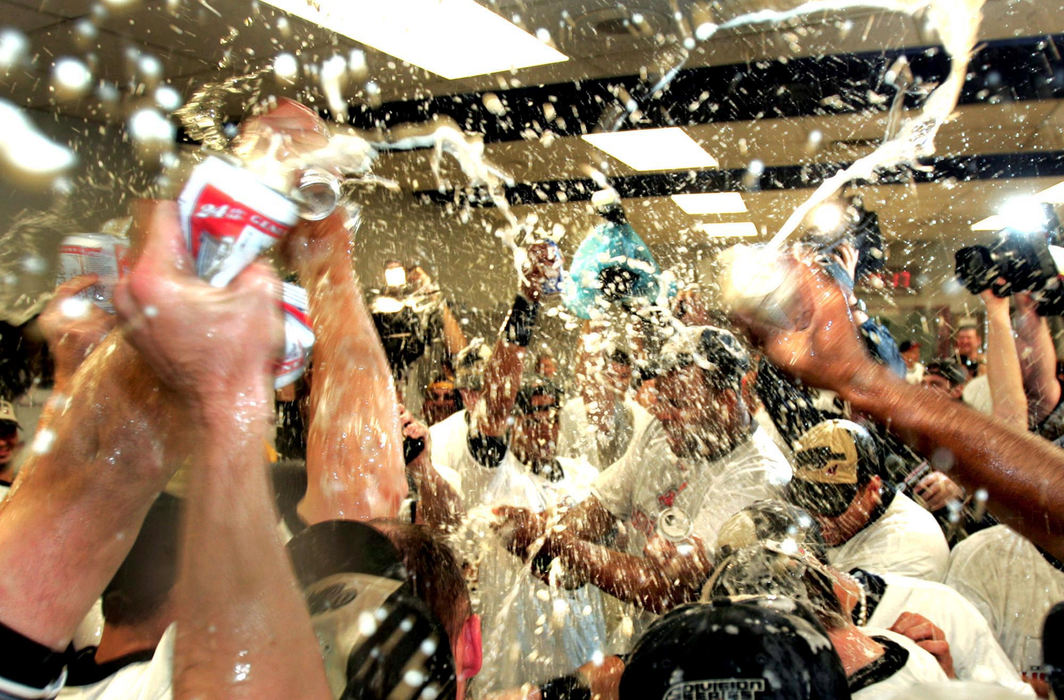 Second Place, Sports Picture Story - Chuck Crow / The Plain DealerThe champagne and beer suds were flowing in the Cleveland Indians locker room after the Indians defeated the Oakland A's 6-2 to clinch the American League Central Divison Title at Jacobs Field on Sept. 23, 2007. Indians pitcher C.C. Sabathia can be seen spraying some champagne.