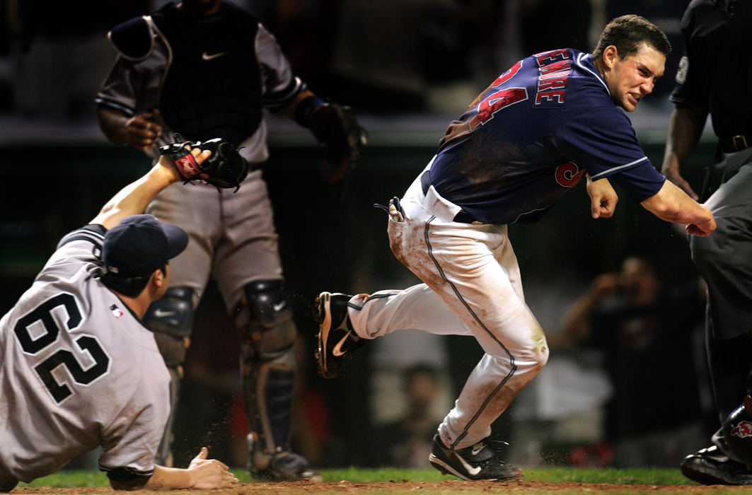 Second Place, Sports Picture Story - Chuck Crow / The Plain DealerIn the Indians first playoff series since 2001,  Grady Sizemore is safe at home, scoring on a wild pitch in the 8th inning as pitcher Joba Chamberlain of the New York Yankees covered home plate too late in the  second game of the American League Division Series. This run tied the game, 2-2, and the Indians went on to win in the 11th inning and take a 2 games to none advantage.