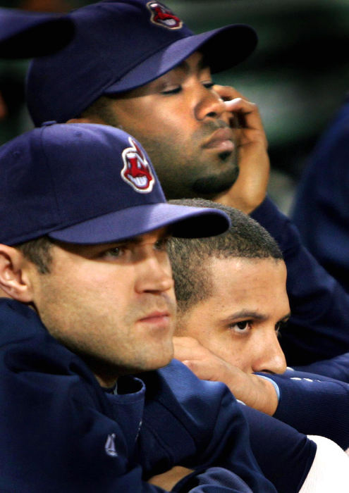 Second Place, Sports Picture Story - Chuck Crow / The Plain DealerCleveland Indians, Kelly Shoppach, Victor Martinez, and Josh Barfield, (front to back) look onto the baseball field at Fenway Park as the Red Sox celebrate after clinching the ALCS in game 7. The Red Sox were advancing to the World Series and the Indians were heading home, the end of their emotional 2007 season.