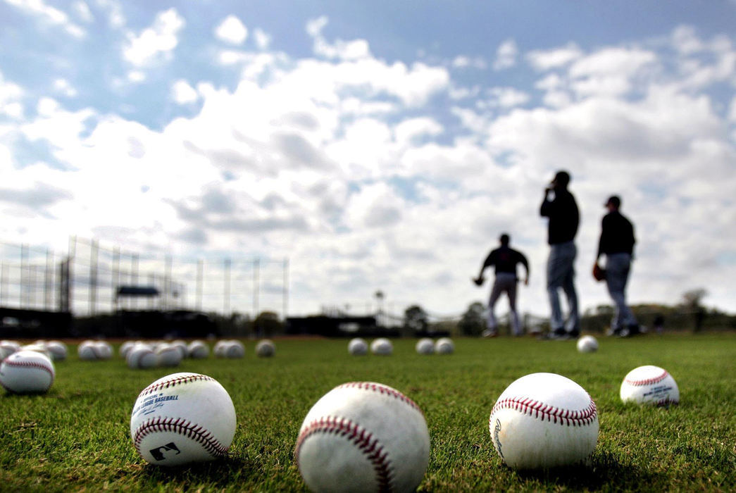 Third Place, Sports Picture Story - Chuck Crow / The Plain DealerThe Cleveland Indians had a season not be forgotten for a long time. For the first time since 2001, they made the playoffs, came within one game of making the World Series, lost a week of baseball due to snow, survived attacks from bugs and birds, and included baseball pranks and crazy plays. This is their wild and wacky season of baseball. Under warm blue skies of a spring day in Winter Haven, Florida, a bunch of baseballs pile up behind 2nd base on the first day of spring training. 