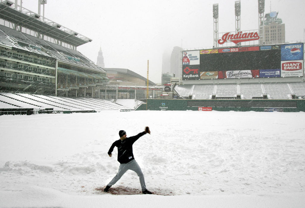 Third Place, Sports Picture Story - Chuck Crow / The Plain DealerSeattle Mariners pitcher Brandon Morrow gets some throwing in on a snowy baseball field at Jacobs Field. A traditional double header between the Seattle Mariners and Cleveland Indians was postponed. The whole opening week of baseball was postponed due to a huge snow storm hitting northeast Ohio.