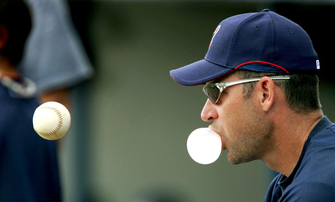 Third Place, Sports Picture Story - Chuck Crow / The Plain DealerCleveland Indians 3rd base coach Joel Skinner blows a bubble while tossing the baseball and keeping his eye on the ball during batting practice.