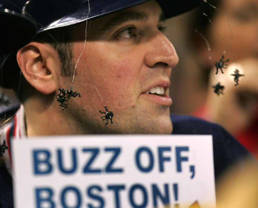 Third Place, Sports Picture Story - Chuck Crow / The Plain DealerMatt Doerfler of Wooster with his own wild bugs in place, tried to rattle the Boston Red Sox during the ALCS but the Red sox prevailed to win the series and advance to the World Series, ending the Indians crazy season.