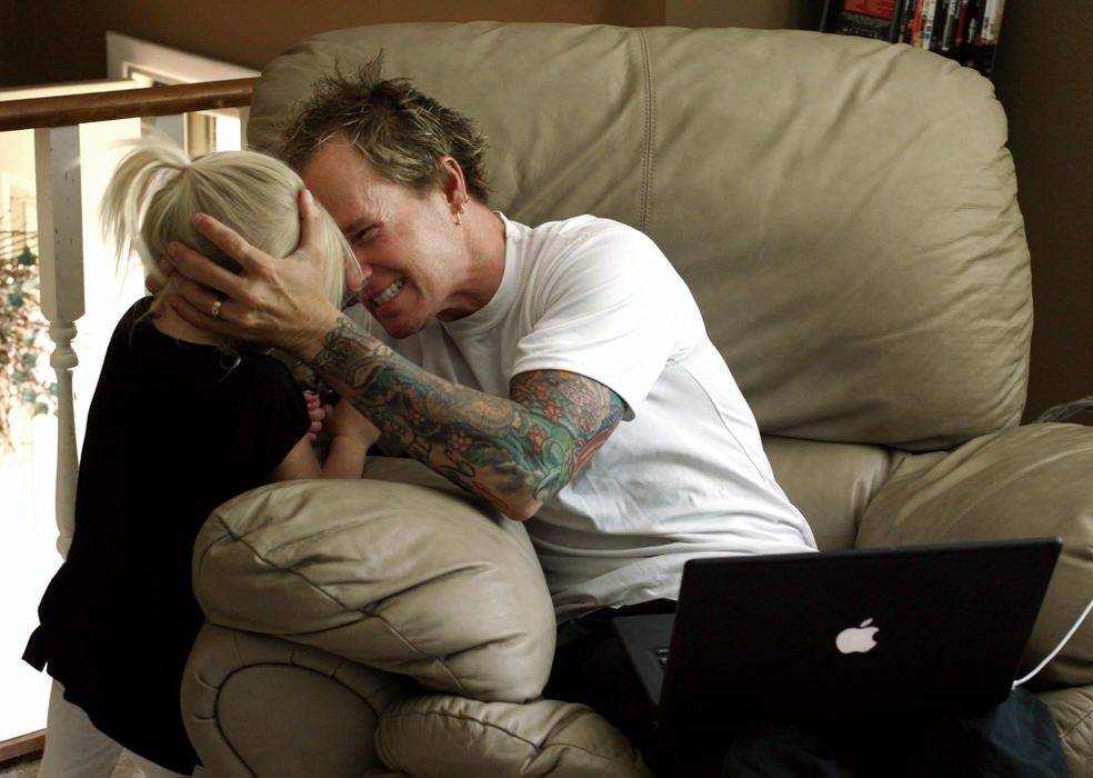 First Place, Sports Picture Story - Andy Morrison / The BladeTodd Crandall plays with daughter Madison, 4, while trying to keep up with his email.