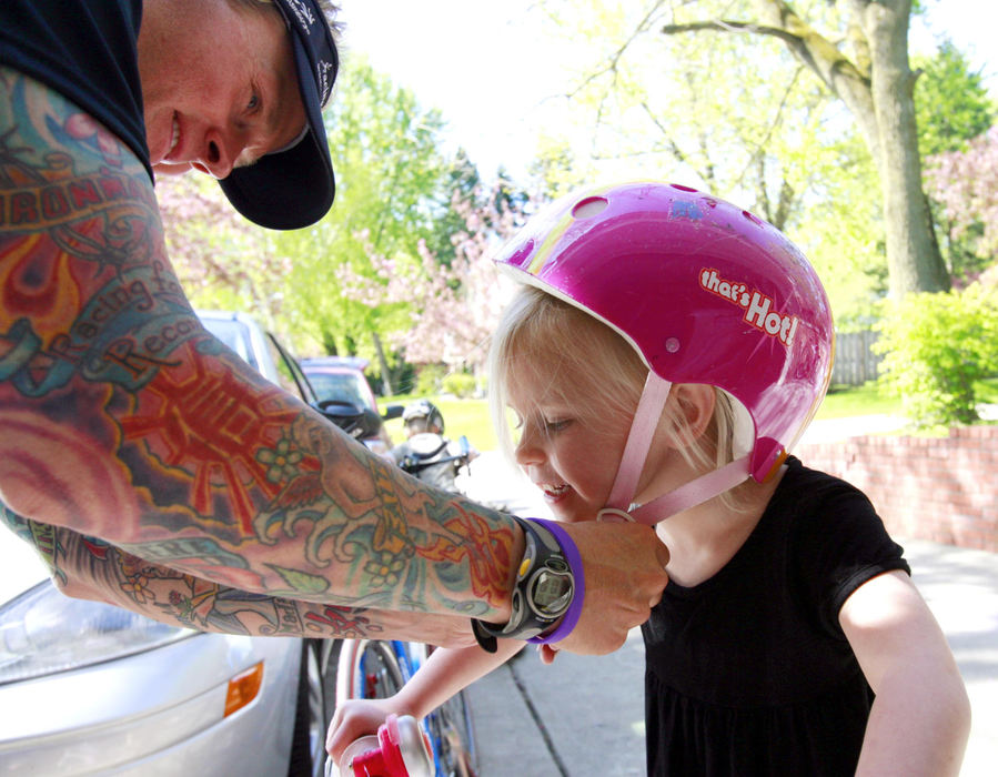 First Place, Sports Picture Story - Andy Morrison / The BladeTodd Crandall and daughter Madison, 4, prepare to go for a ride around the neighborhood.