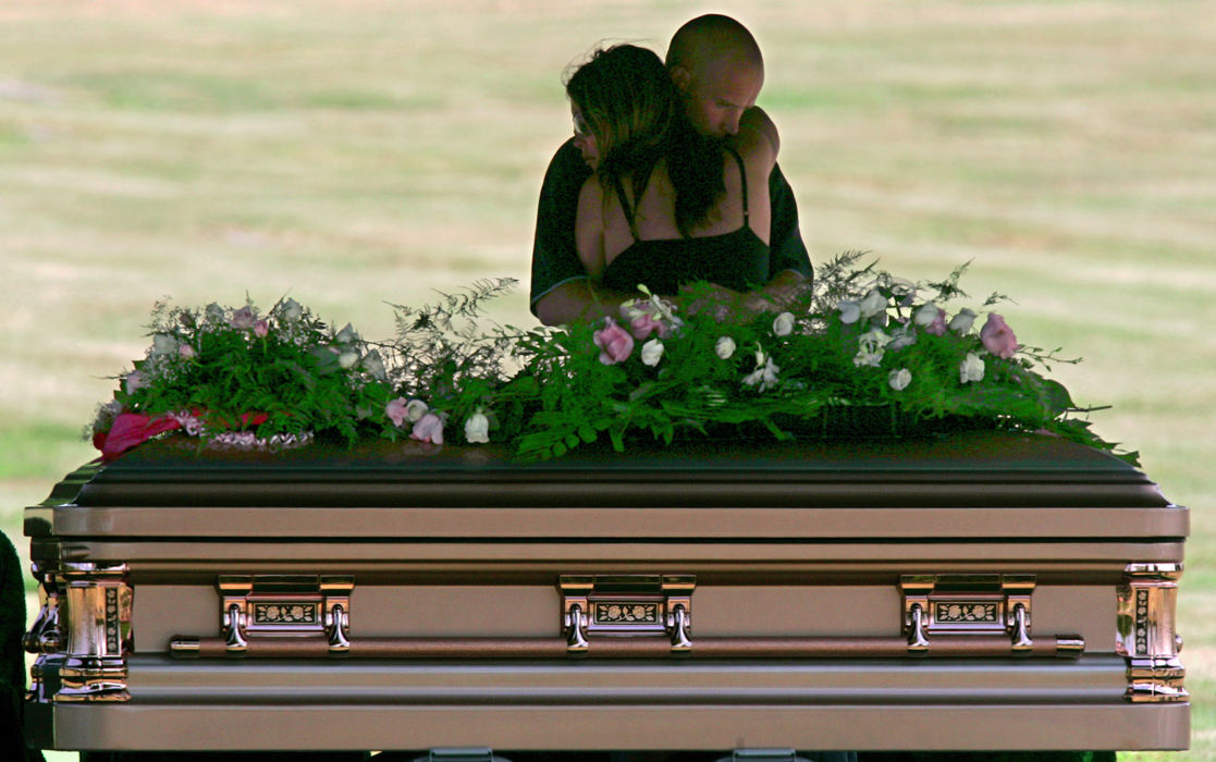 First Place, Team Picture Story - Ed Suba Jr. / Akron Beacon JournalSarah Crislip of Coventry Township, a friend of Jessie Marie Davis, is comforted by boyfriend Scott Sander of Canton during the burial service at Greenlawn Cemetery in Akron. Crislip and Davis attended Coventry High School, where they both studied sports medicine.                                                                                                                                                                  