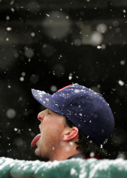 Second Place, Team Picture Story - chuck crow / The Plain DealerIndians outfielder Trot Nixon tries to catch some snow flakes during a snow delay in the second inning.