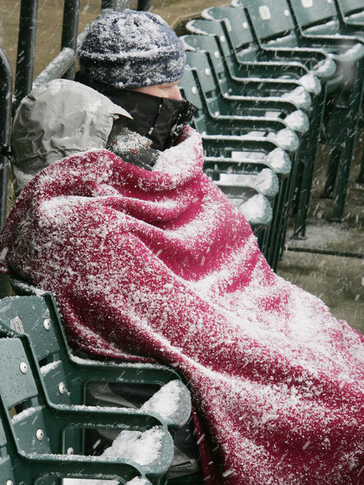 Second Place, Team Picture Story - JOHN KUNTZ / The Plain DealerLuke and Linda Drury of Caper, Wyo., said they did not bring the snow with them as they sit in their seats huddled under a blanket during the home opener.