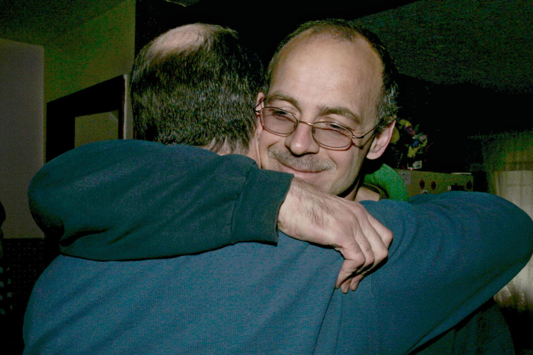 Third Place, Team Picture Story - Mike Cardew / Akron Beacon JournalRandy Resh (left) hugs friend Bob Gondor at Gondor's home after Resh was acquitted in a retrial. Prosecutors will consider whether to proceed with Gondor's retrial in a 1988 murder.