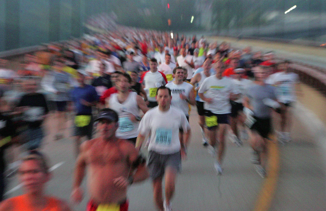 Award of Excellence, Team Picture Story - Ken Love / Akron Beacon JournalRunners cross the northbound side of the All-America Bridge on North Main Street in Akron, just after the start of the 5th annual Road Runner Akron Marathon.
